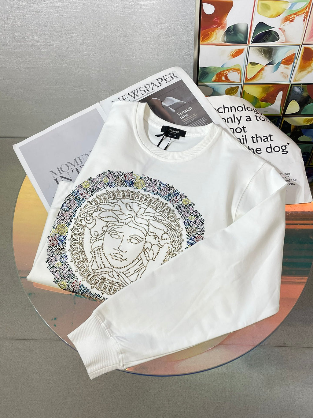 White long-sleeve sweatshirt with Medusa rhinestone emblem on front