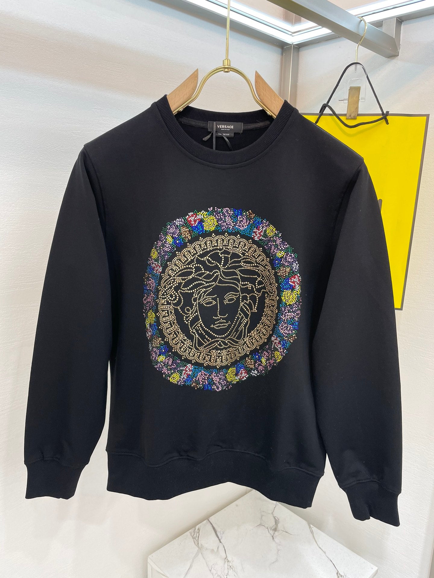 Black crewneck sweatshirt with multicolor rhinestone Medusa medallion