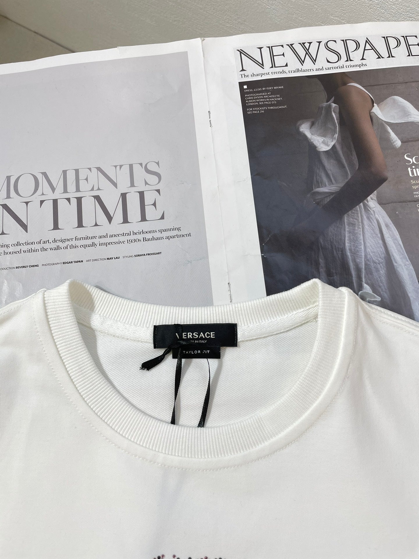 White crewneck sweatshirt with brand label at neckline