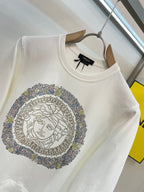 White crewneck sweatshirt featuring rhinestone Medusa medallion artwork