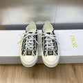 Navy blue logo-print low-top sneakers with white laces and white rubber sole.