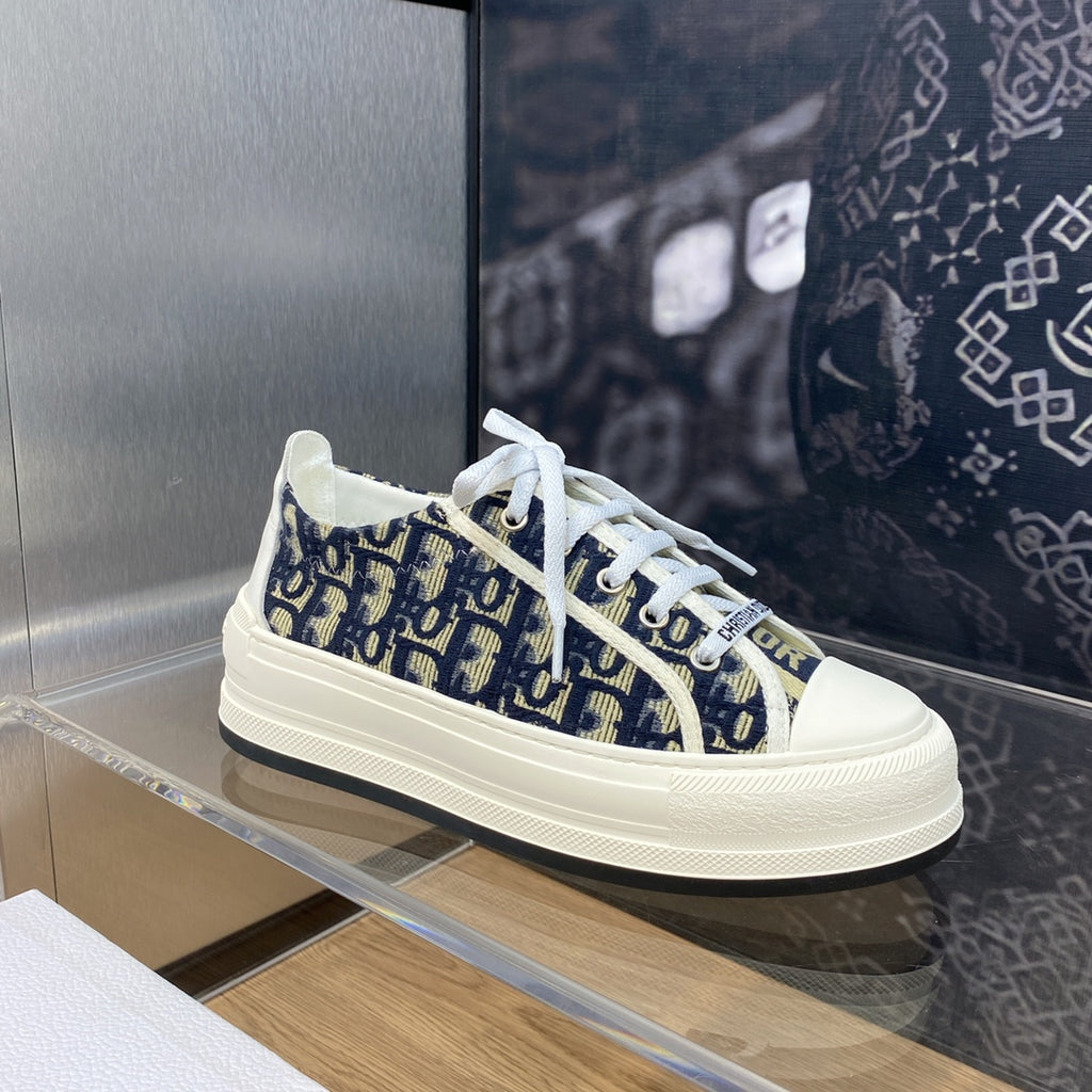 Navy blue logo-print sneakers with white laces and Dior-branded tongue detail.