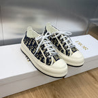Navy blue monogram low-top sneakers with white laces and Dior-branded tongue.