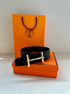 Hermes black leather belt with metal buckle, flat lay