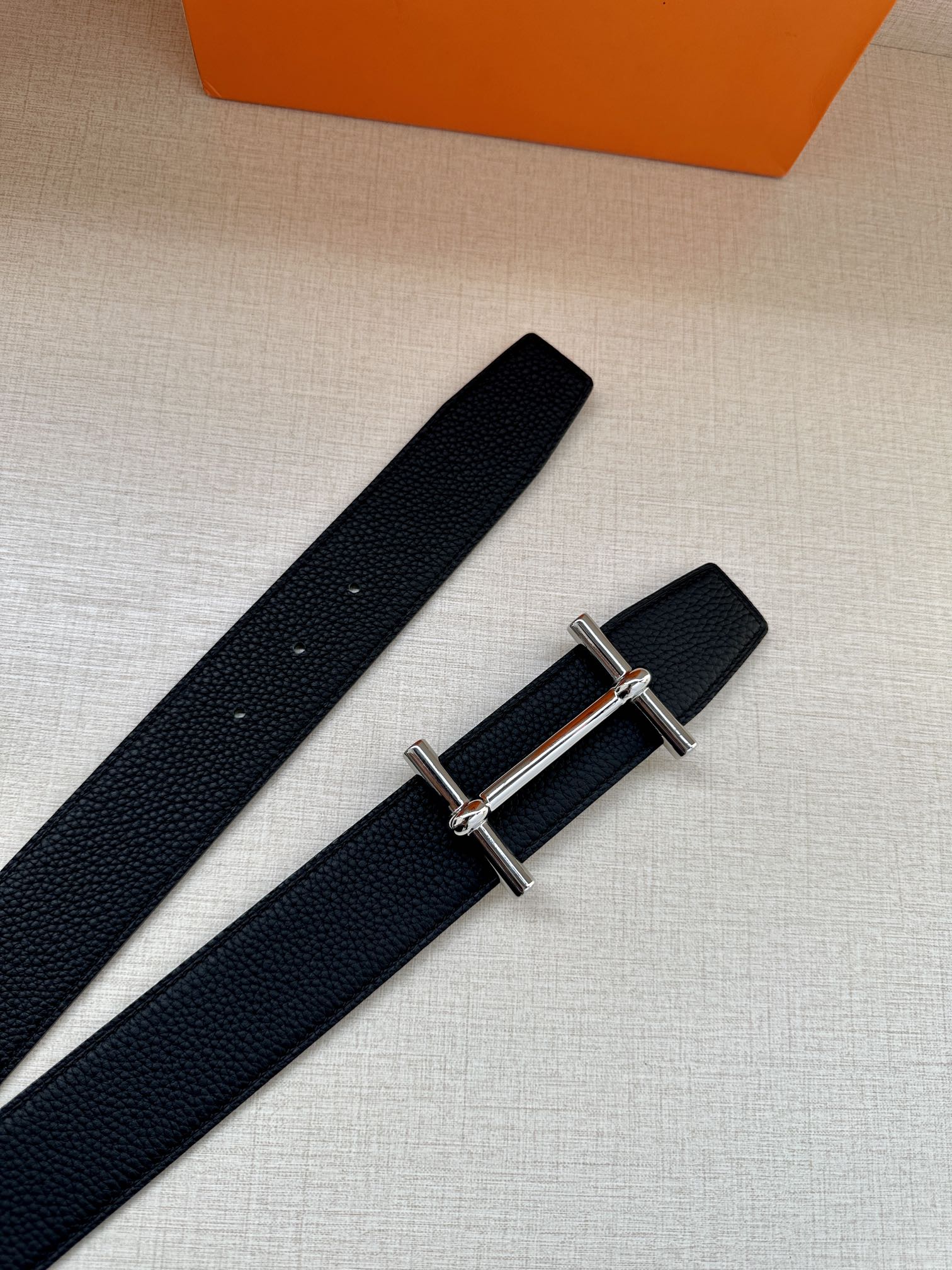 Hermes black leather belt with metal buckle, long strap view