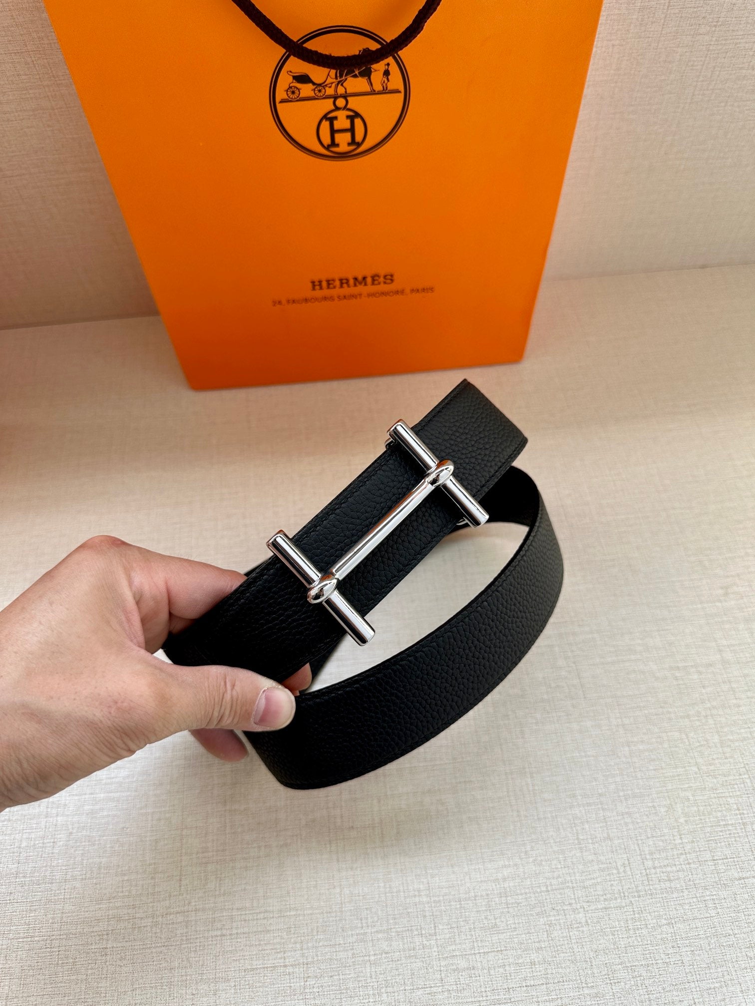 Hermes black leather belt with metal buckle, close-up loop