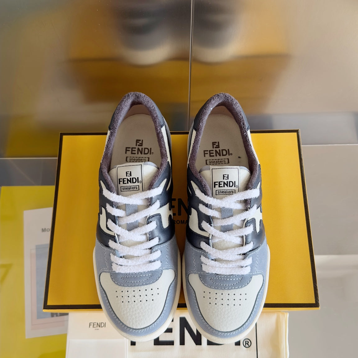 Fendi unisex sneakers front view, light gray and white with dark navy lace-up panels