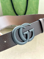 Gucci belt detail with gray leather strap and silver-tone double G buckle