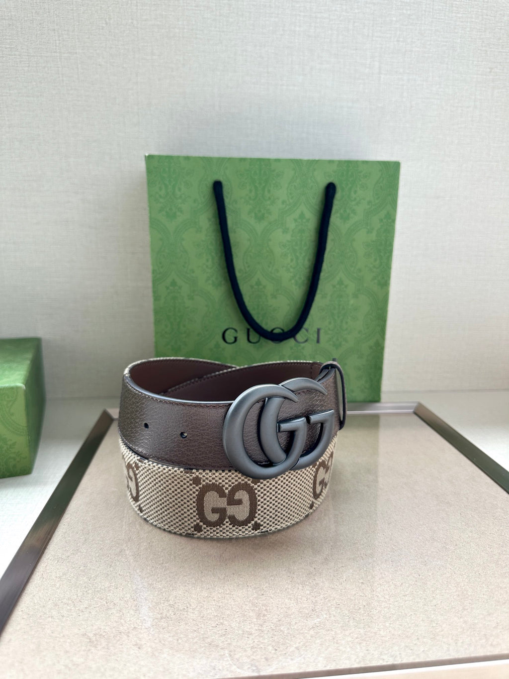 Gucci GG monogram belt with dark gray leather strap and silver-tone double G buckle