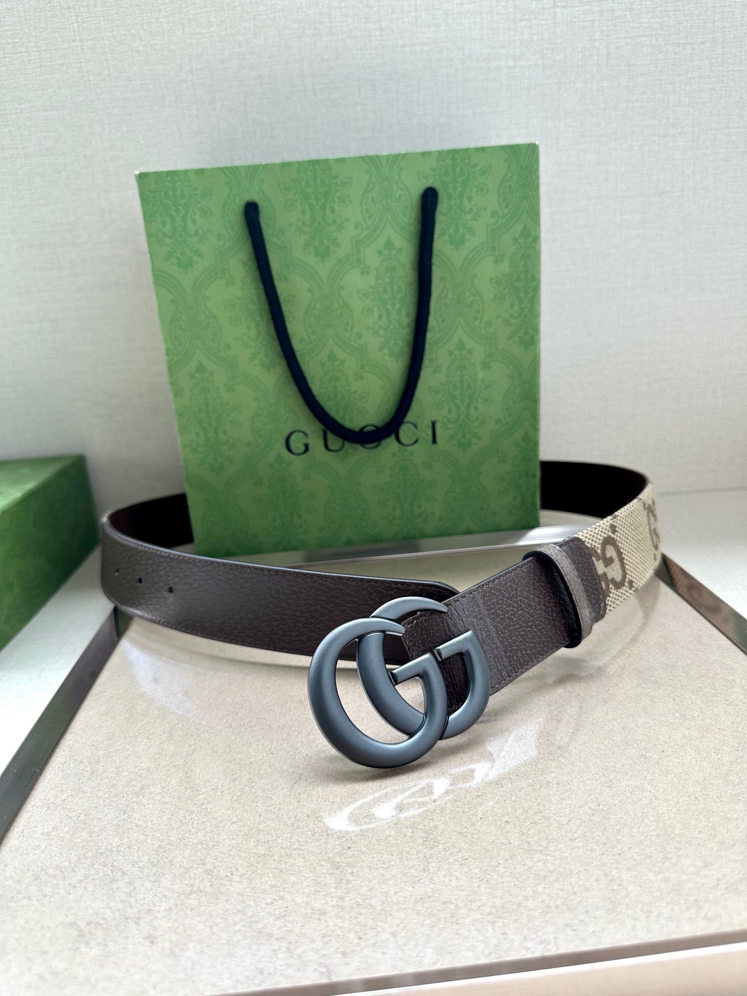 Gucci belt with GG canvas center and dark gray leather strap, silver double G buckle