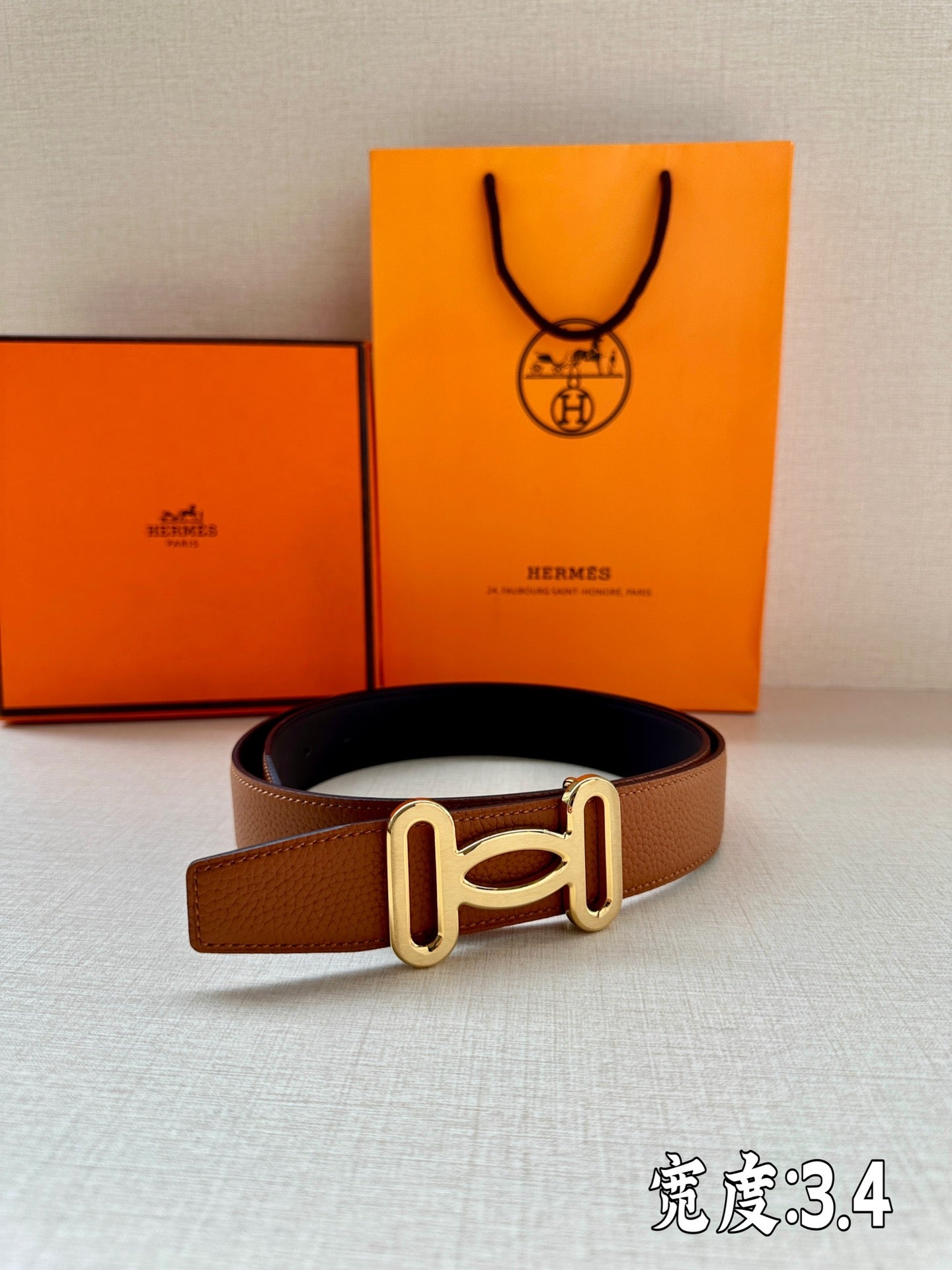 Tan leather belt with gold-tone H buckle
