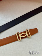 Tan leather belt with gold-tone H buckle, close-up