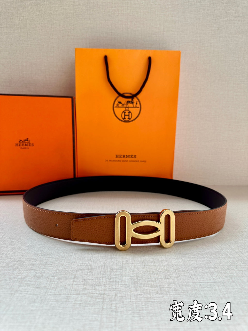 Tan leather belt with gold-tone H buckle
