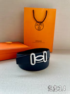 Hermes belt in dark blue leather with silver-tone buckle, front view.