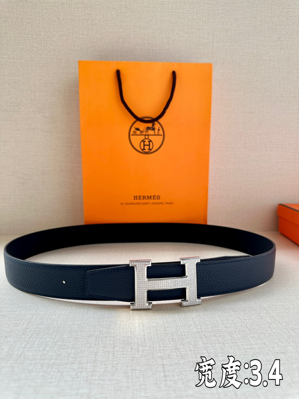 Dark blue leather belt with silver Hermès H buckle and punched adjustment holes