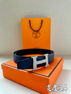 Dark blue leather belt with silver Hermès H buckle, full front view