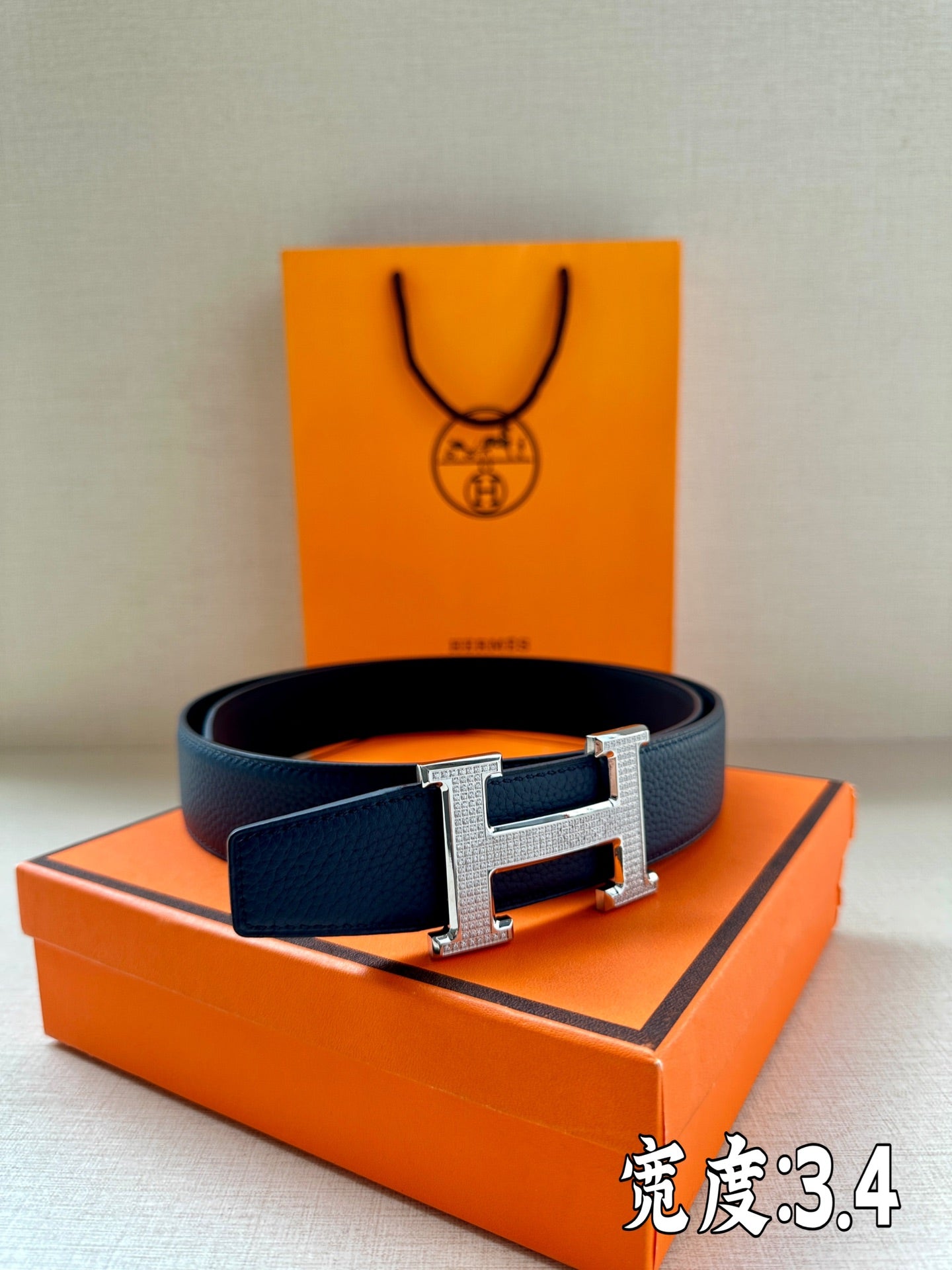 Dark blue leather belt with silver Hermès H buckle, full front view