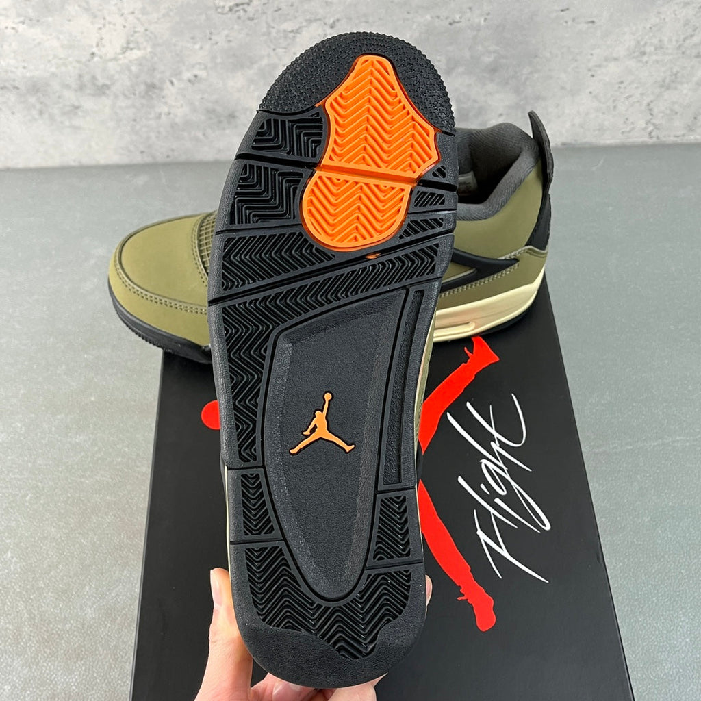 Air Jordan 4 sneaker outsole with orange traction section and dark gray tread