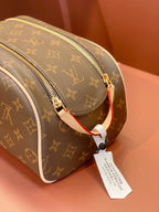 Louis Vuitton monogram toiletry bag with side zip track and red strap pull