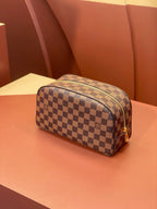 Louis Vuitton checkered toiletry bag with zip-top and brown leather trim.