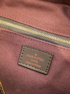 Louis Vuitton Paris made in France label on maroon fabric lining tag.