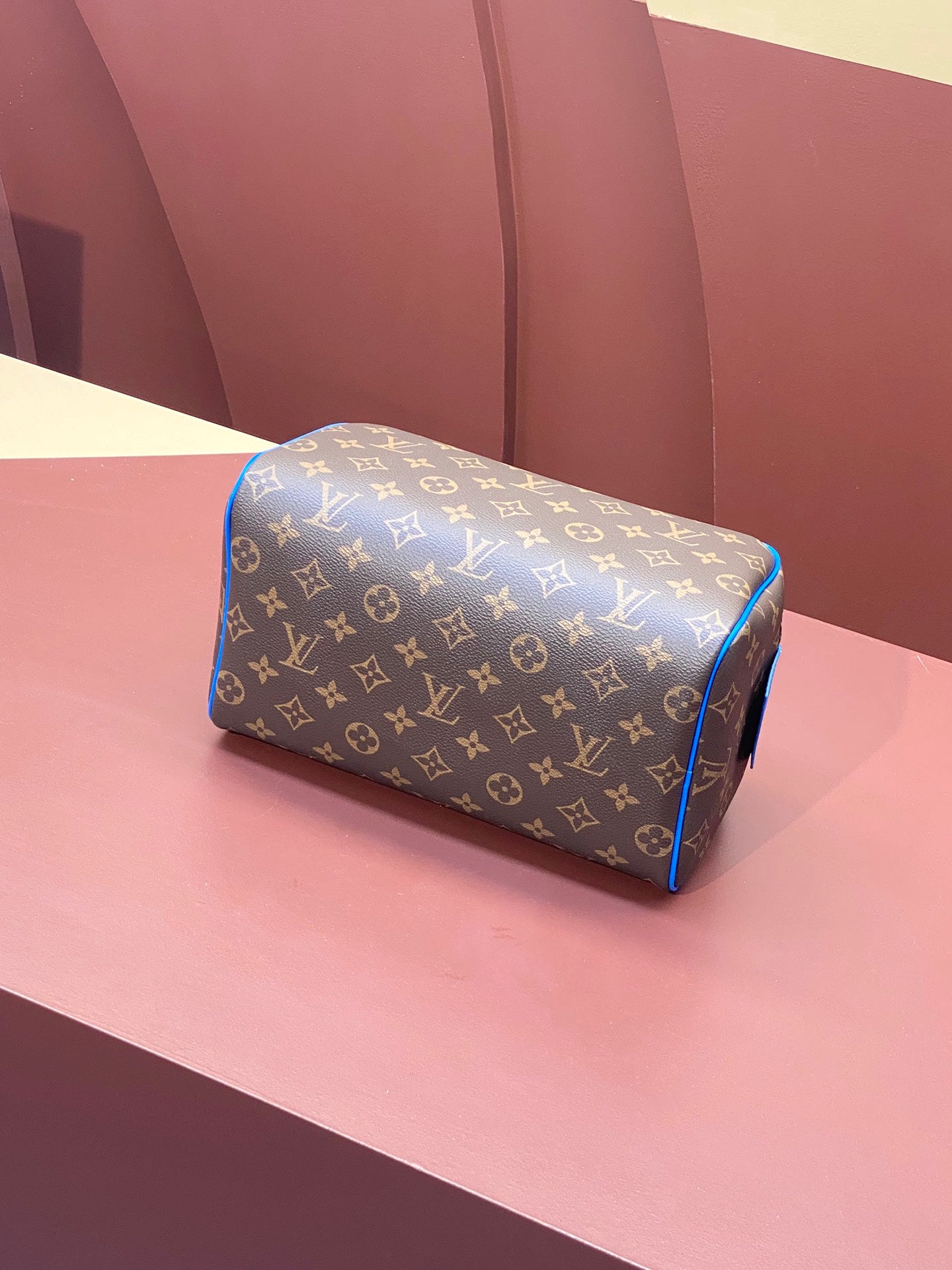 Louis Vuitton monogram canvas bag with blue piping and top zip closure