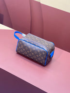 Louis Vuitton monogram canvas bag with blue trim and top zipper, side view