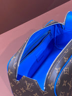 Open Louis Vuitton monogram bag showing bright blue interior and zip pocket