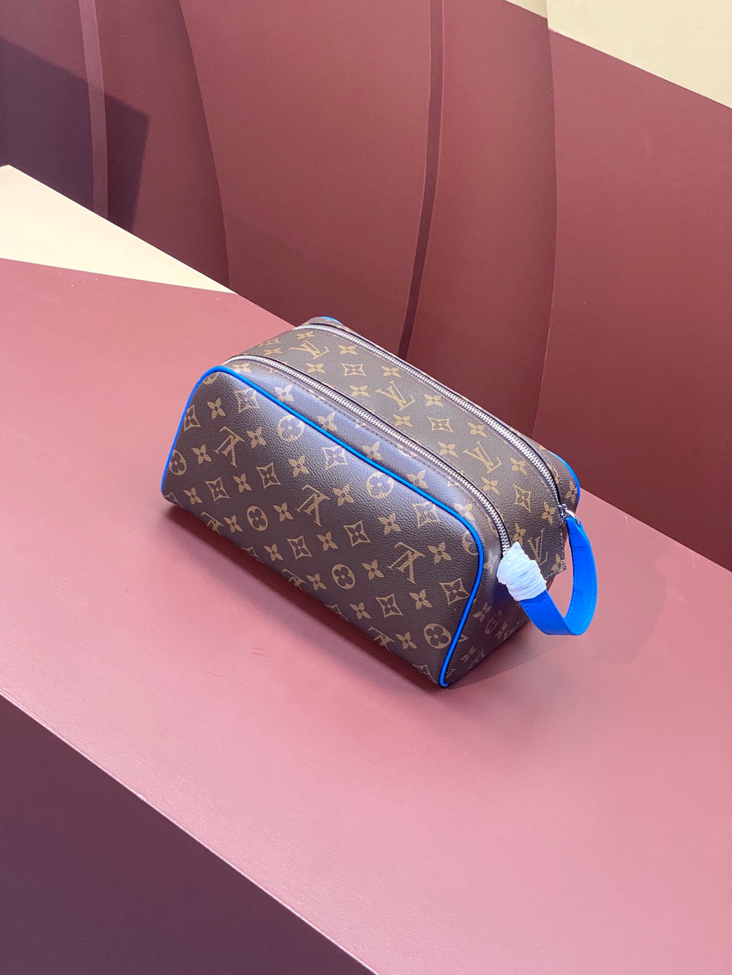 Louis Vuitton monogram toiletry bag with blue leather trim and zippered opening