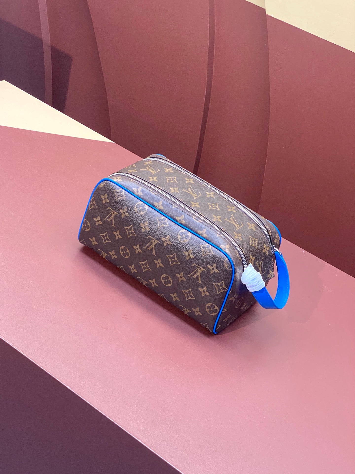Louis Vuitton monogram toiletry bag with blue leather trim and zippered opening