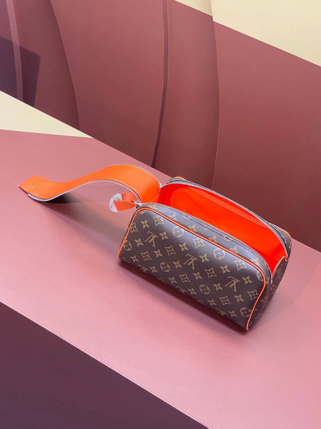 Louis Vuitton monogram crossbody bag with orange handle and open top zip