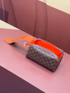 Louis Vuitton monogram crossbody bag with orange handle and open top zip