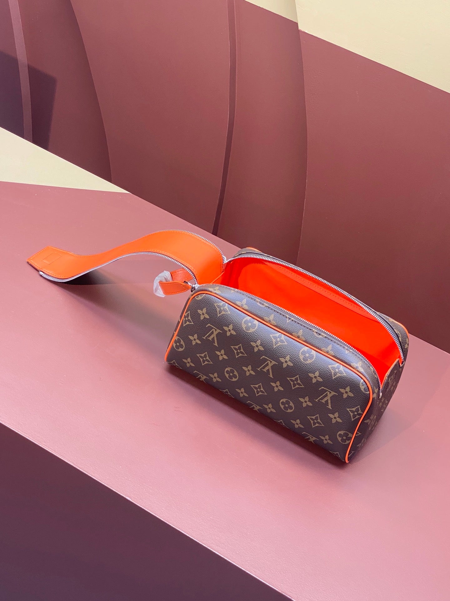 Louis Vuitton monogram crossbody bag with orange handle and open top zip