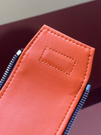 Orange interior zip pocket with stitched edge on Louis Vuitton monogram bag