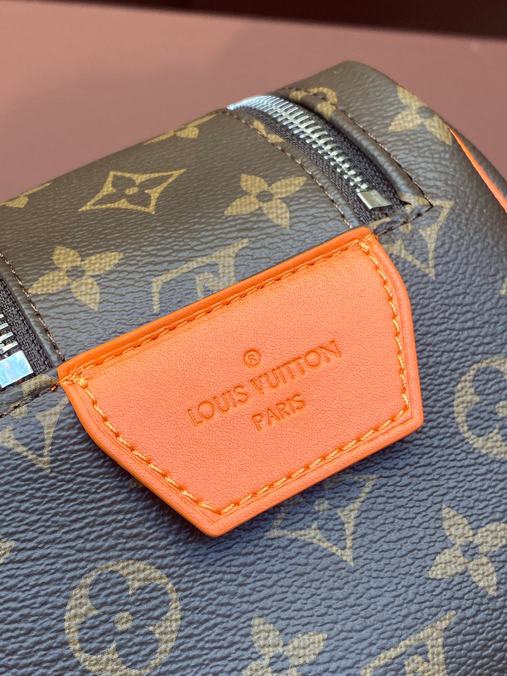 Louis Vuitton monogram bag with orange leather name tag and stitched edge