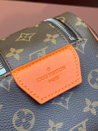 Louis Vuitton monogram bag with orange leather name tag and stitched edge