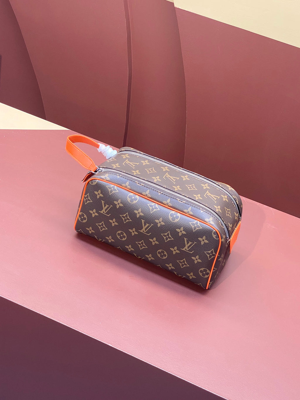 Louis Vuitton monogram crossbody bag with orange trim and top zip