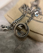 GG heart pendant with braided edge on silver-toned chain necklace