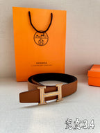 Brown leather belt with silver-toned H buckle on display