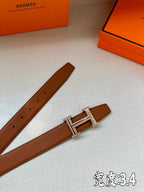 Brown leather belt with silver-toned H buckle and row of adjustment holes