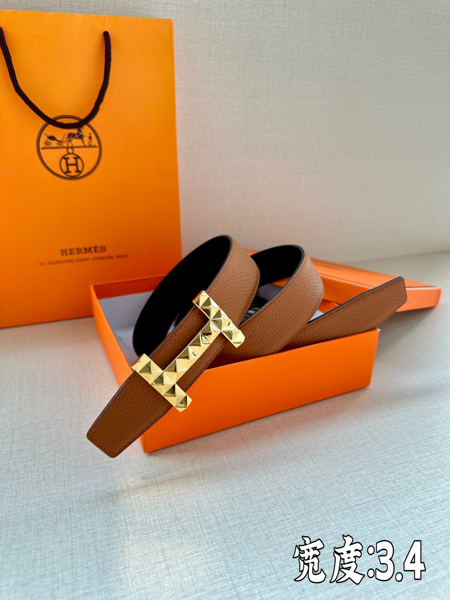 Hermes leather belt with tan-brown strap and gold-tone square stud buckle