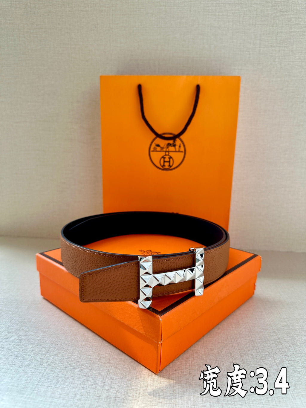 Hermes leather belt with tan-brown strap and silver-tone stud buckle
