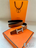 Hermes leather belt with tan-brown strap and silver-tone geometric stud buckle