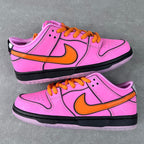 Pair of pink low-top sneakers with orange laces, orange swoosh, and black midsole