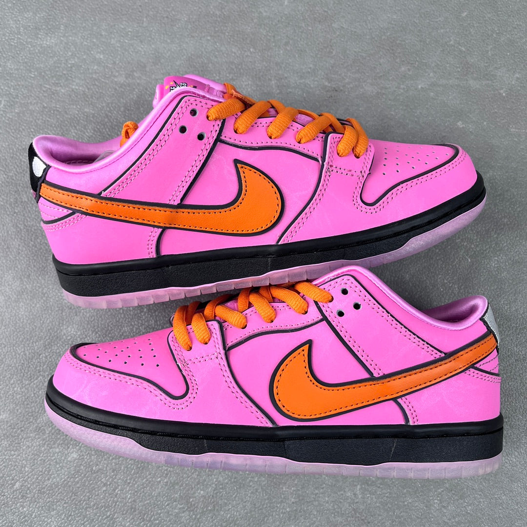 Pair of pink low-top sneakers with orange laces, orange swoosh, and black midsole