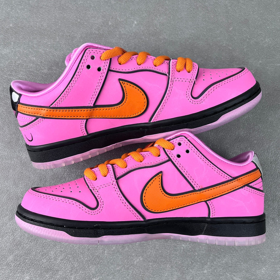 Two pink low-top sneakers shown together with orange swooshes, orange laces, black soles