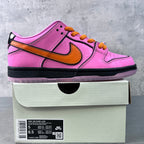 Pink low-top sneakers with orange Nike swoosh, orange laces, and black sole on box