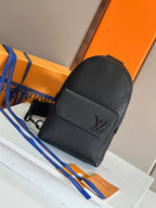 Louis Vuitton mini crossbody bag in dark textured leather with front flap and LV logo