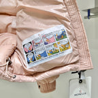 Moncler light pink puffer jacket sleeve lining with colorful printed graphic patch