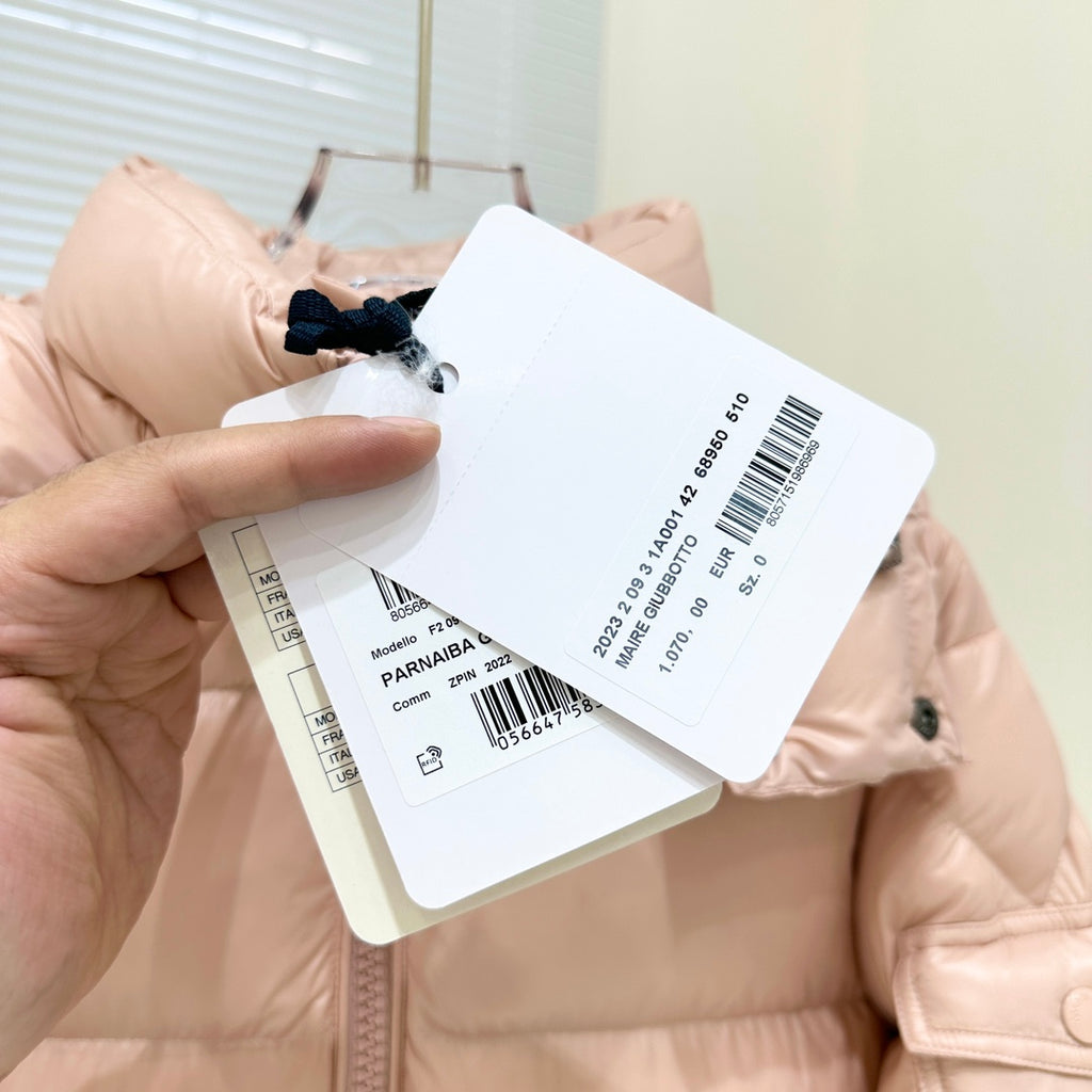 Moncler light pink puffer jacket with front zipper and hanging white product tags